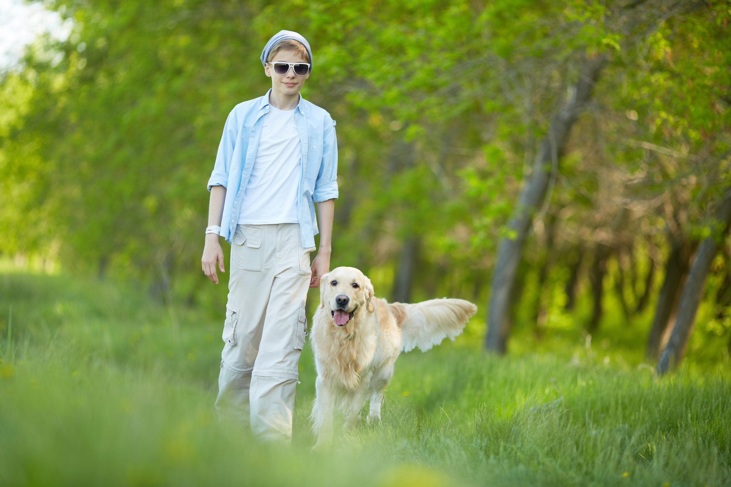 A man and his golden retriever enjoying a spring day outside.