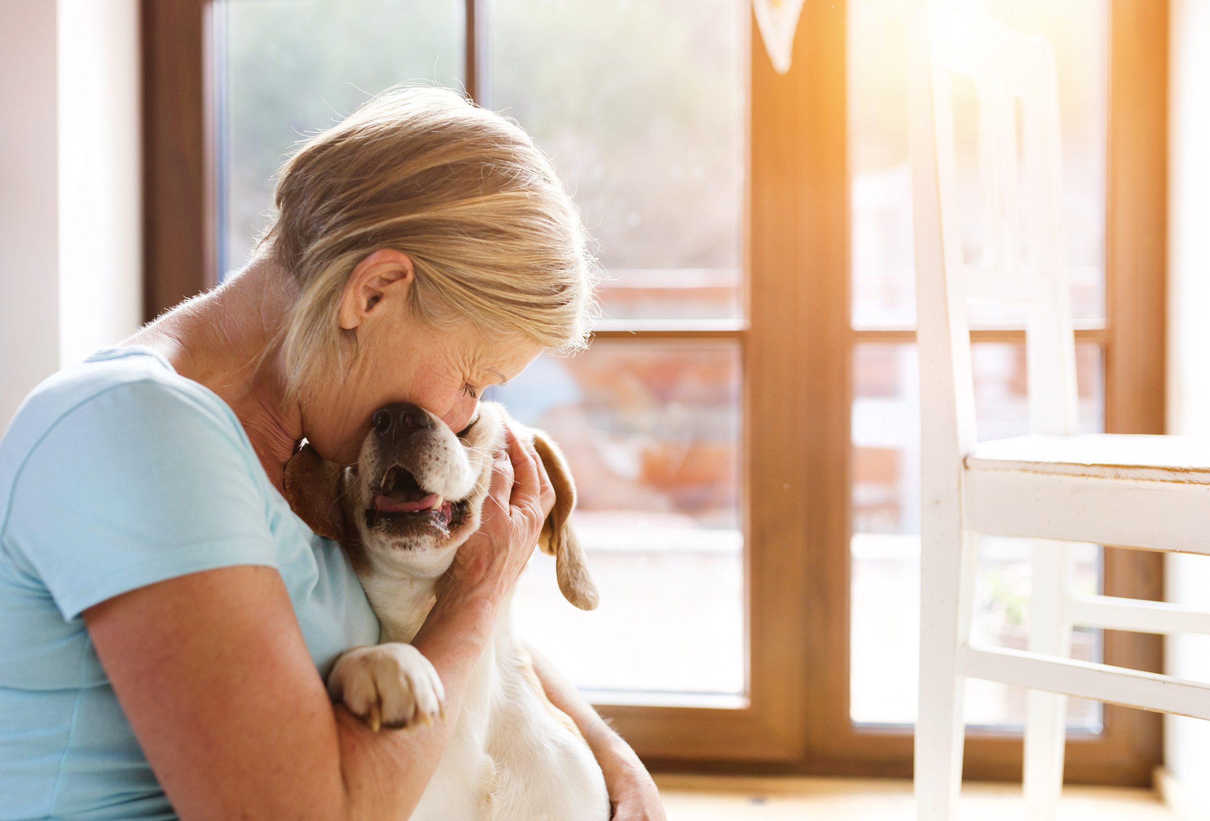 An older woman cuddling her emotional support animal in Boston.