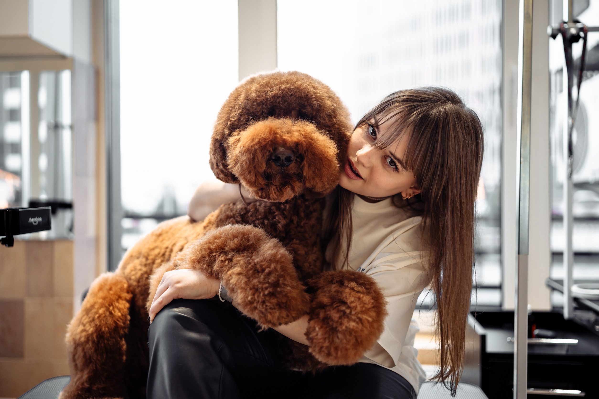 A woman hugging her emotional support animal in her home in Hialeah, FL.