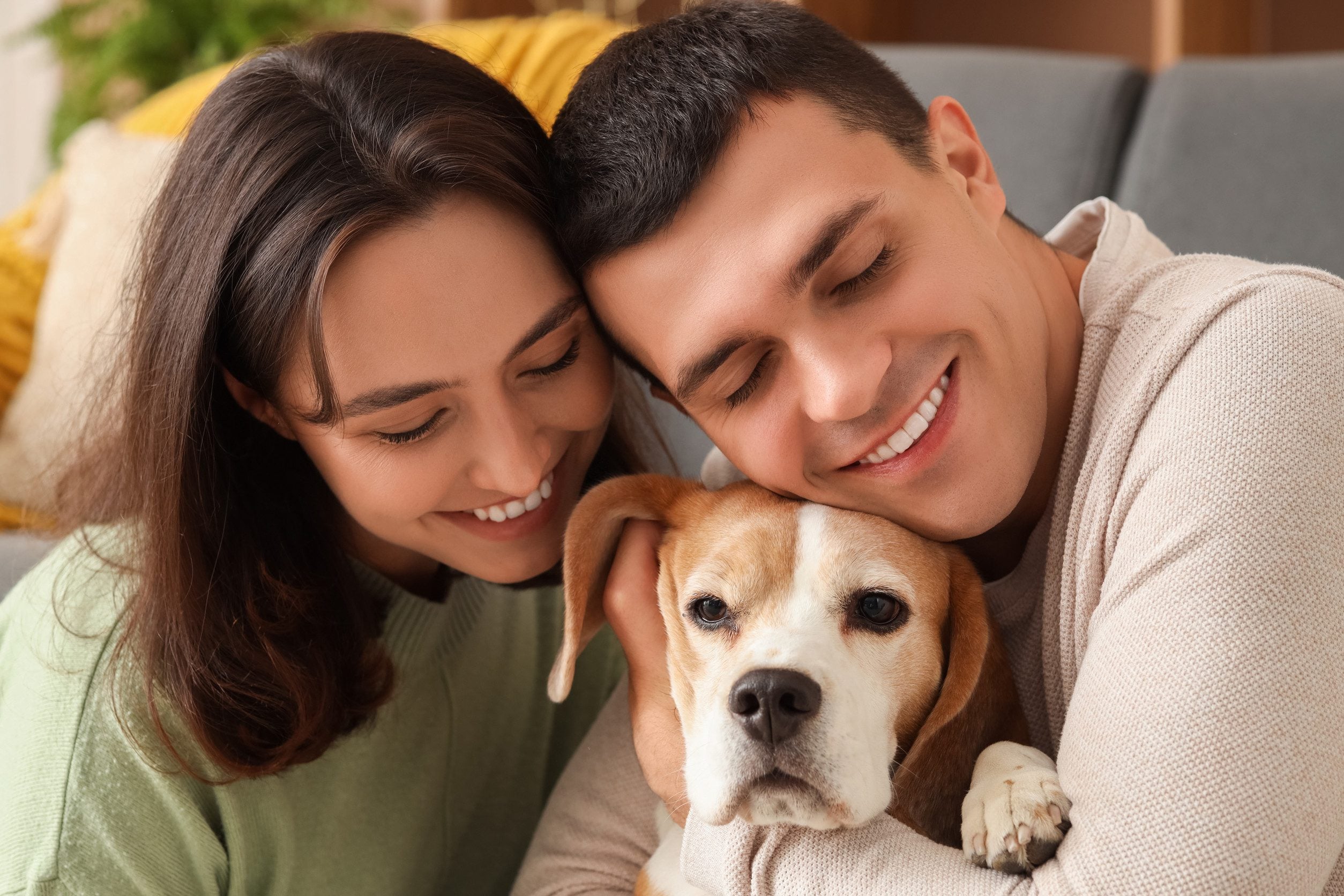 Family snuggling up to emotional support animal.